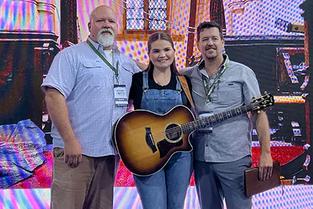 Duck Hunters Expo Church Service - pastor with singers and guitar