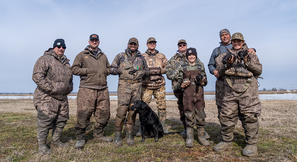 Group of hunters and black lab after an Arkansas hunt