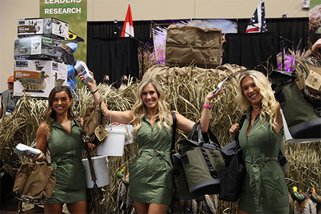 Grand Duck Hunters Banquet - three raffle women holding up auction prizes