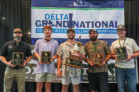 Delta Grand National Champions - five men and their plaques/trophy