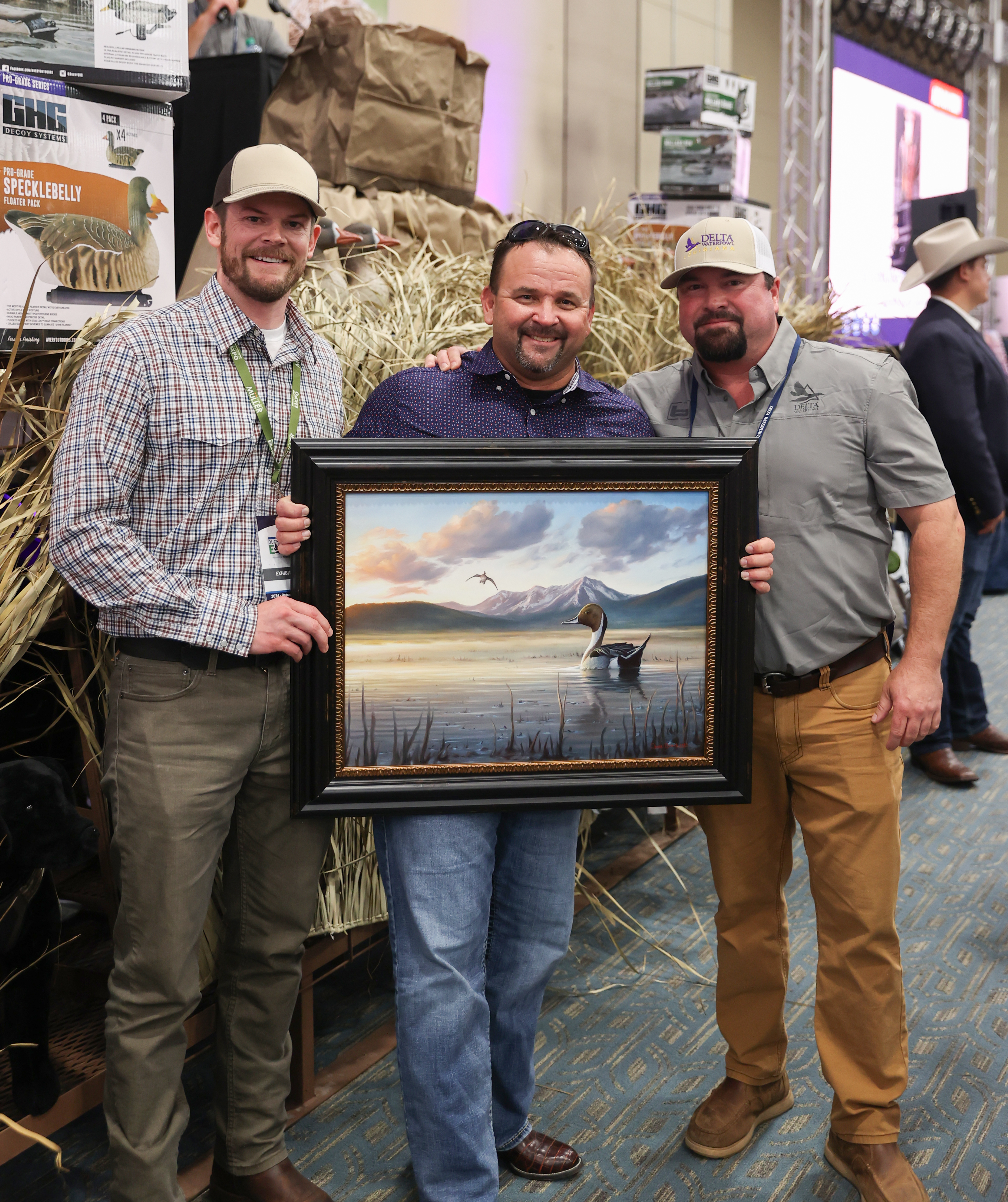 Grand Duck Hunters Banquet - Bryan Leach with volunteer, and auction winner holding Pintail painting